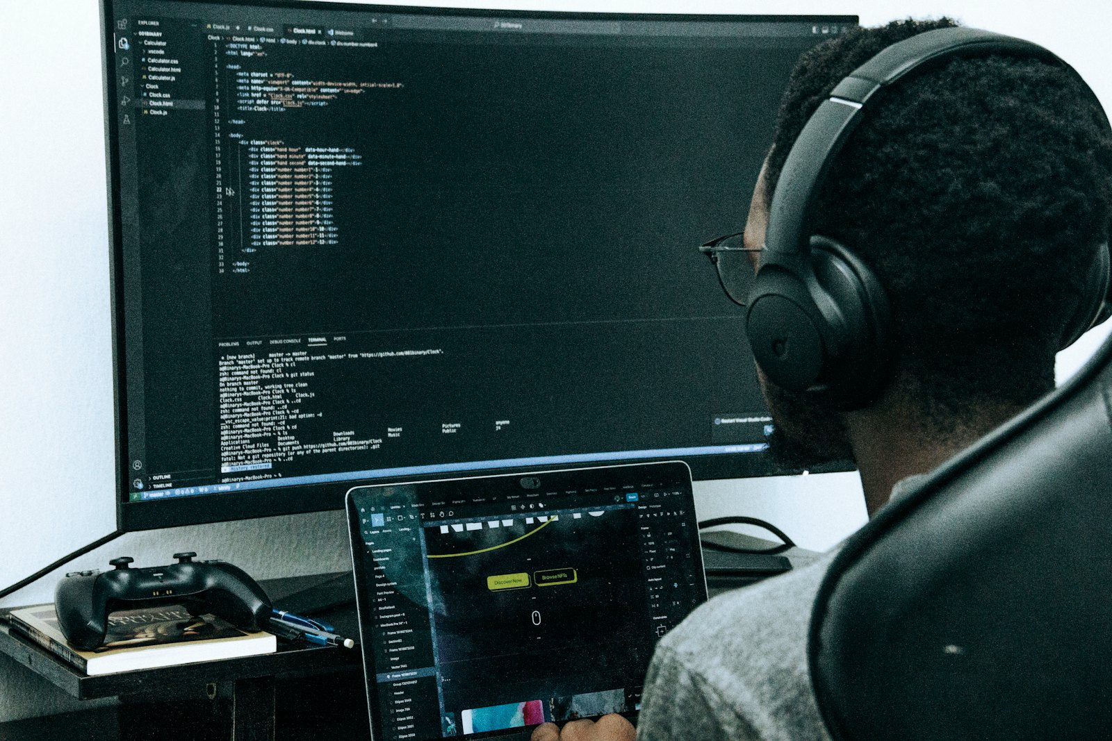A developer working at a desk with two screens